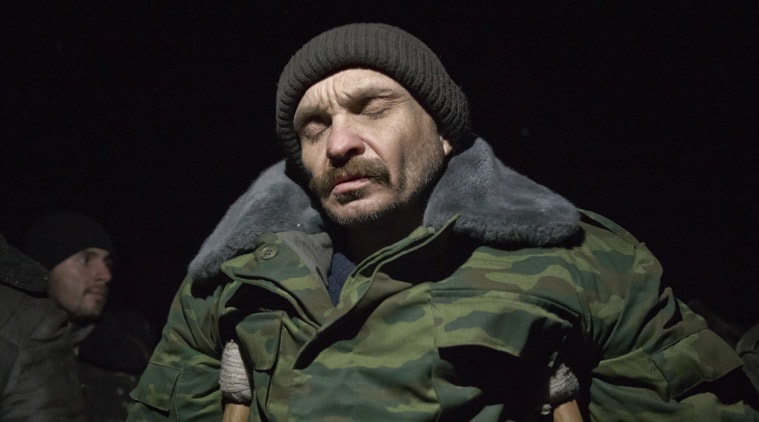 An Ukrainian prisoner of war leans on crutches before a prisoner exchange in Russia-backed separatist controlled territory, near Zholobok, Ukraine, Saturday, Feb. 21, 2015. Ukrainian military and separatist representatives exchanged dozens of prisoners under cover of darkness at a remote frontline location Saturday evening. 139 Ukrainian troops and 52 rebels were exchanged, according to a separatist official overseeing the prisoner swap at a no man’s land location near the village of Zholobok, some 20 kilometers (12 miles) west of Luhansk. (AP Photo/Vadim Ghirda)