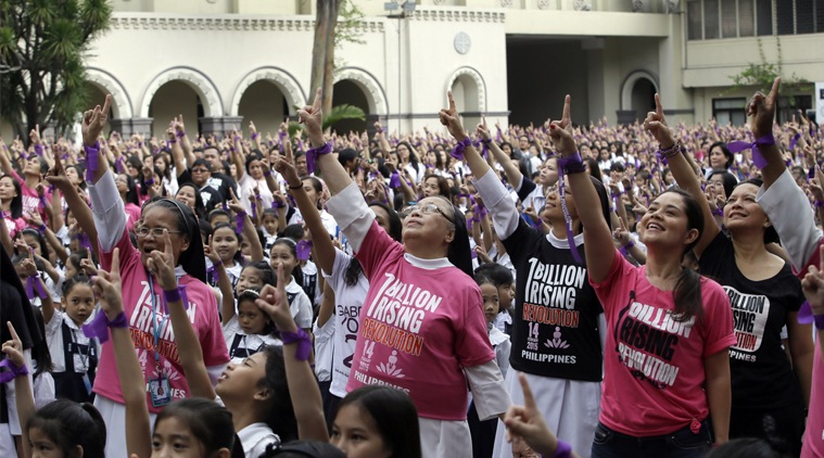One billion rising, Philippines, One billion rising Philippines, UN global campaign women, UN global campaign rape, UN global campaign against rape, UN campaign, UN global campaign, Monique Wilson, World Newspurple ribbons on their wrists, more than 3,000 students, teachers and nuns from the Catholic-run St. Scholastica's College in Manila, flash the No.1 sign as they dance at their quadrangle to take part in the global campaign to end violence against women and girls dubbed One Billion Rising, Friday, Feb. 13, 2015 in Manila, Philippines. (AP Photo