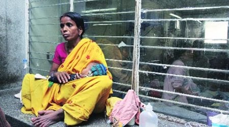 A woman waiting with her child outside Deen Dayal Upadhyay Hospital, New Delhi.