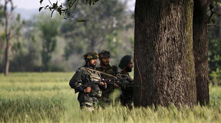 Soldiers take position behind a tree as they watch a gun battle between suspected militants and security forces in Kathua district, about 80 kilometers (50 miles) south of Jammu. (Source: AP photo)