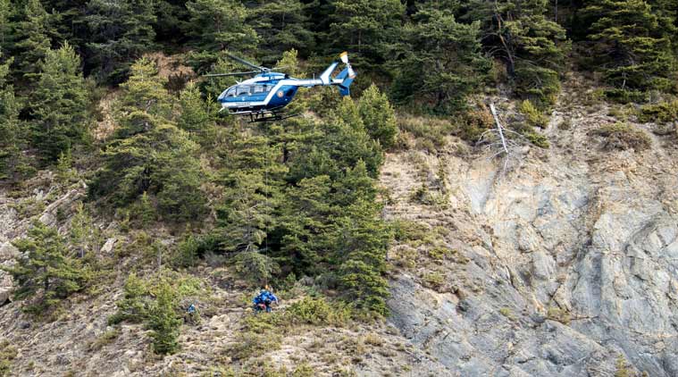 This photo provided by the Gendarmerie Nationale shows rescue workers being rappelled from an helicopter on the crash site near Seyne-les-Alpes, French Alps, Wednesday, March 25, 2015. French investigators cracked open the badly damaged black box of the Germanwings plane on Wednesday and sealed off the rugged Alpine crash site where 150 people died when their plane on a flight from Barcelona, Spain to Duesseldorf, Germany, slammed into a mountain Tuesday. (AP Photo/Fabrice Balsamo, Gendarmerie Nationale)