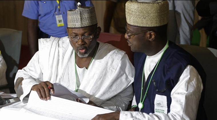 Independent National Electoral Commission chairman, Attahiru Jega, left, views election results at the coalition center in Abuja, Nigeria, Monday, March 30, 2015