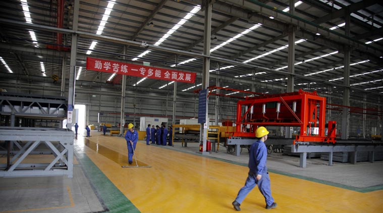 In this March 20, 2015 photo, workers walk through the Broad Sustainable Building Co. in Yueyang in central China's Hunan Province. The Chinese construction company is claiming to be the world’s fastest builder after erecting a 57-story skyscraper in 19 working days in central China. The company put up the rectangular, glass-and-steel Mini Sky City using a modular method, assembling three floors per day, company vice president Xiao Changgeng said. (AP Photo/Peng Peng)