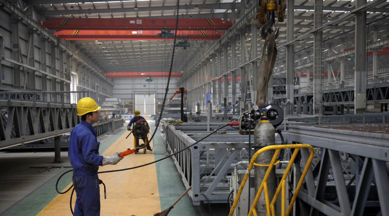 In this March 20, 2015 photo, a worker operates machinery at the Broad Sustainable Building Co. in central China's Hunan Province. The Chinese construction company is claiming to be the world’s fastest builder after erecting a 57-story skyscraper in 19 working days in central China. The company put up the rectangular, glass-and-steel Mini Sky City using a modular method, assembling three floors per day, company vice president Xiao Changgeng said. (AP Photo/Peng Peng)