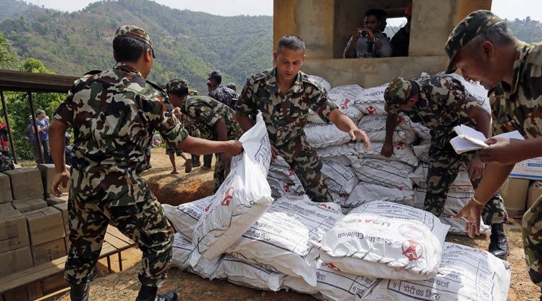Nepalese soldiers load U.S. AID relief sacks at landing zone near Saturday's massive earthquake's epicenter in the town of Gorkha, Nepal, Tuesday, April 28, 2015. Preparing to make a push into the most isolated parts of quake-devastated Nepal, soldiers on Tuesday were readying food, water and other emergency supplies to be loaded onto helicopters in this small town near the earthquake's epicenter. (AP Photo/Wally Santana)