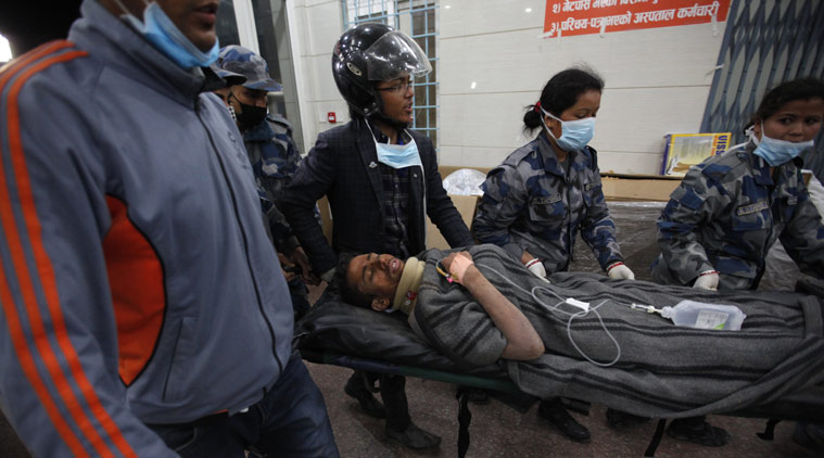 Survivor Rishi Khanal, 27, is carried on a stretcher after being freed by French rescuers from the ruins of a three-story hotel in the Gangabu area of Kathmandu, Nepal, Tuesday, April 28, 2015. Across central Nepal, including in Kathmandu, the capital, hundreds of thousands of people are still living in the open without clean water or sanitation since Saturday’s massive earthquake, one of the worst to hit the South Asian nation in more than 80 years. (AP Photo/Niranjan Shrestha)
