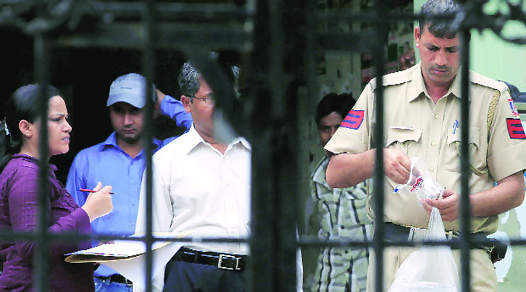 Police outside the office of Bharat Singh in Najafgarh after he was shot at in 2012. (Source: EXpress photo)
