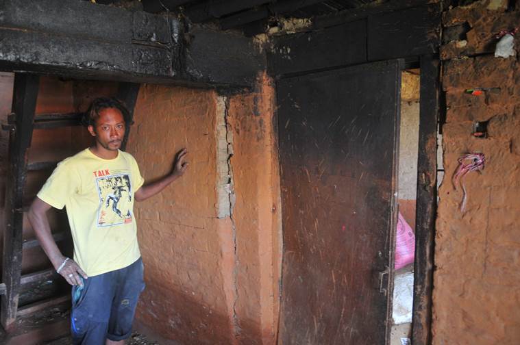 A villager shows his cracked house. (Prashant Ravi)