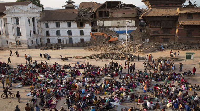 People gather on an open space for security reasons at the Basantapur Durbar Square, damaged in Saturdays earthquake in Kathmandu, Nepal, Sunday, April 26, 2015. (AP Photo)