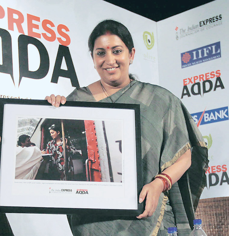 Smriti Irani with a memento presented by The Indian Express. The photograph from 2009 shows Irani signing autographs as she travels in a local train from Bandra to the BJP office at Churchgate, Mumbai