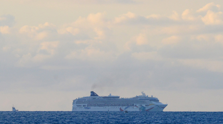 In this photo provided by the Royal Gazette, the Norwegian cruise ship Norwegian Dawn, lies aground near Bermuda's North Channel Tuesday, May 19, 2015. Thousands of passengers bound for Boston will spend Tuesday night stuck aboard a Norwegian cruise ship after it ran aground as it tried to depart Bermuda, officials and passengers said. (Akil Simmons/The Royal Gazette photo via AP)