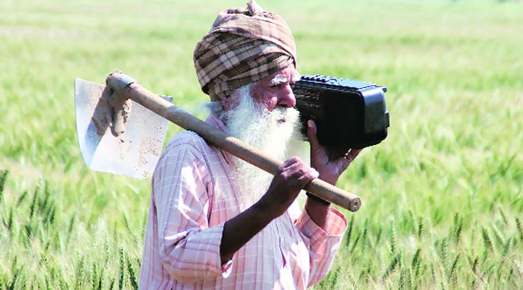 A farmer in Malakpur village in Punjab listening to the Prime Minister’s radio address — ‘Mann ki Baat’.(Express Photo by: Gurmeet Singh)