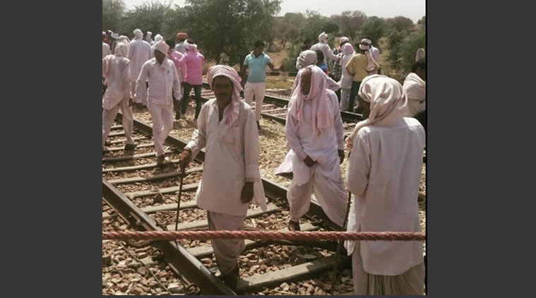 Around 500-700 members of the community are present at the railway tracks near Pilukapura in the district. (Source: Mahim Pratap Singh)