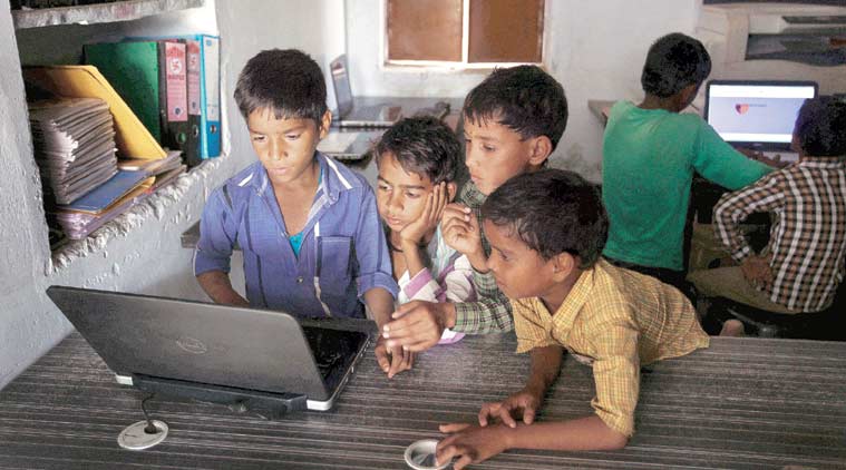 (Top) Children at the Internet centre in Chandauli say they are friends with Mark Zuckerberg on Facebook and translate his posts on Google Translate. (Source: Express photo by Oinam Anand)