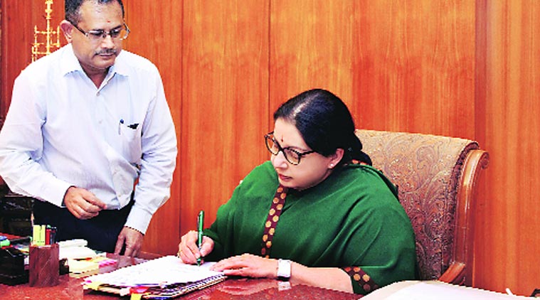 J Jayalalithaa signs a file at the secretariat in Chennai on Sunday.(Source: PTI)