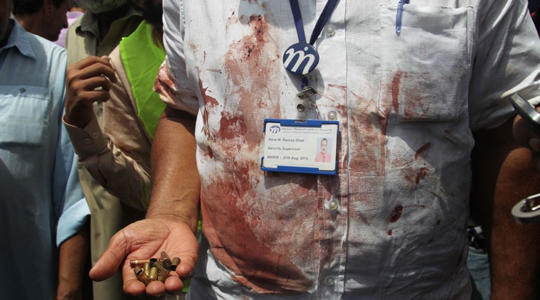 A Pakistani security official displays cartridges he collected from the scene of an attack on a bus, in Karachi, Pakistan, Wednesday, May 13, 2015. Gunmen killed dozens of people on Wednesday aboard a bus in southern Pakistan bound for a Shiite community center, in the latest attack targeting the religious minority, police said. (AP Photo/Fareed Khan)