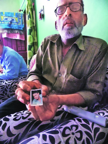 Irfan with his son Rizwan’s photograph. (Express Photo by: Milind Ghatwai)