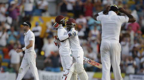 West Indies' captain Denesh Ramdin, center left, and teammate Jermaine Blackwood embrace after beating England by five wickets during day three of their third Test match at the Kensington Oval in Bridgetown, Barbados, on Sunday. (Source: AP photo)