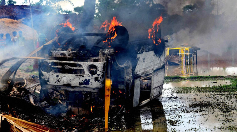 Local protesters torched two school vans following recovery of the bodies of two students of a residential public school located near Nirpur village in Bihar's Nalanda district on Sunday. (Source: PTI photo)
