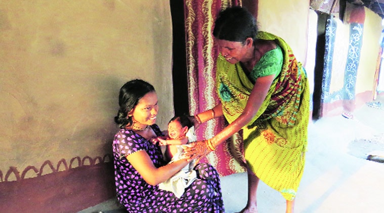 Vetti Meena with her newborn in a camp in Dornapal — wife of an SPO, she grieves that they can never leave. (Source: Express photo by Ashutosh Bhardwaj)