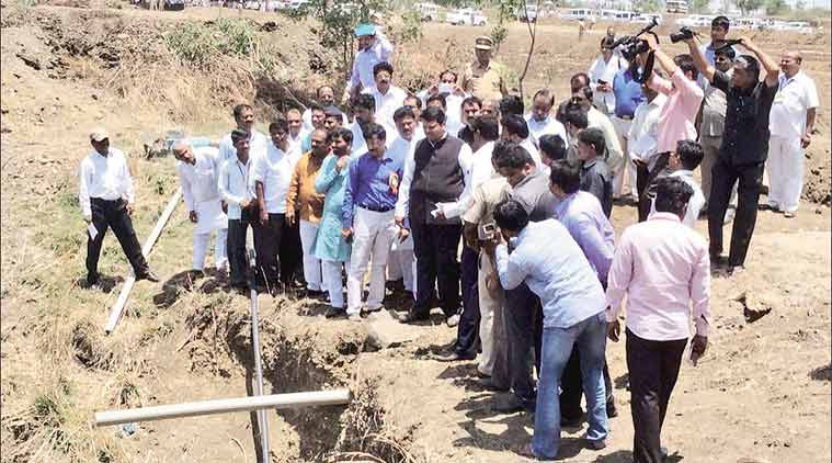 Maharashtra  CM Devendra Fadnavis and other officials at a project site in Ingalgi village, Solapur. (Source: Express photo)