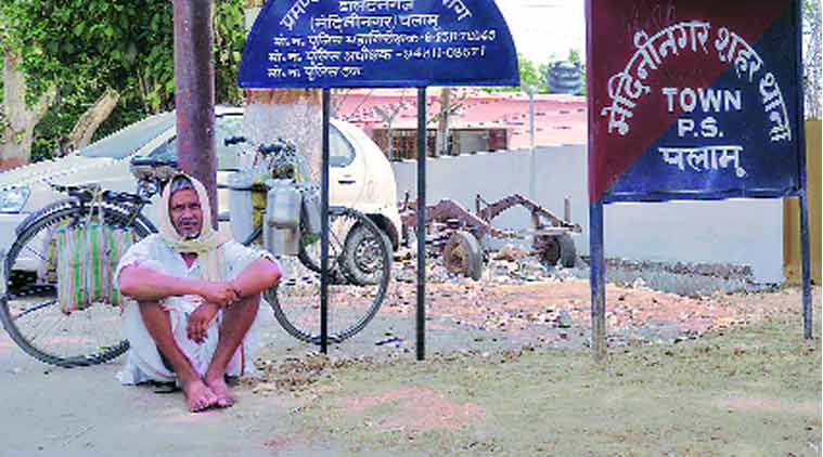 Izaz’s uncle waits for his body outside the police station, Wednesday.(Express Photo by: Shiv Kumar)