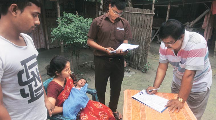 Officials from India and Bangladesh at Prakash Barman’s house, seeking information on their newborn, at Shibprasad Mustafi, a Bangladeshi enclave in India. (Source: Express photo by Partha Paul)