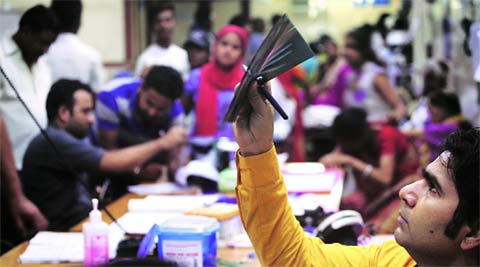 A doctor checks an X-ray in the ER of Sanjay Gandhi Memorial. (Source: Express photo by Oinam Anand)