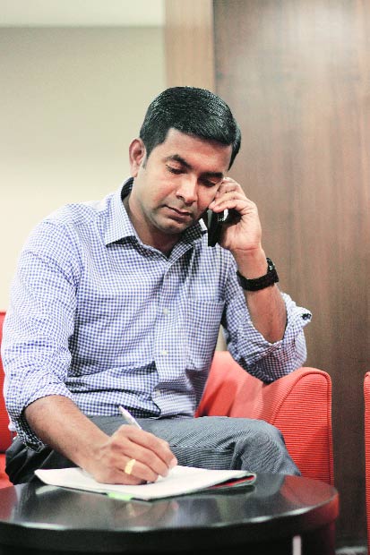 Vinod Venugopal counsels a client over the phone in Trivandrum 