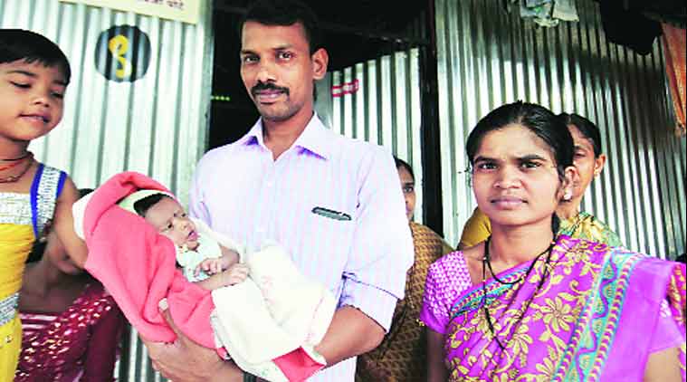 Ankusha Pote, the first baby born after the Malin landslide, with her parents at a temporary shelter in Malin. (Express Photo by: Arul Horizon)
