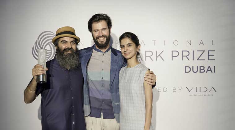 Suket Dhir and wife Svetlana pose with a model dressed in the winning garment 