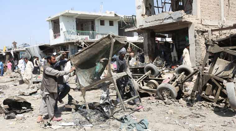 Afghans work the site of a car bomb attack in Kabul. (Source: AP)