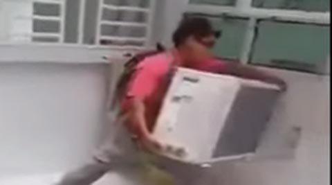 Video: Chinese man’s risky feat as he installs an AC