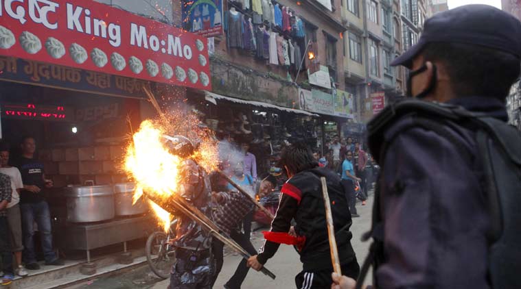 Nepalese protesters hit a policeman with a torch during a rally in Kathmandu, Nepal, Saturday, Aug. 15, 2015. Supporters of small opposition parties protested to oppose the constitution drafting process. (Source: AP photo/file)