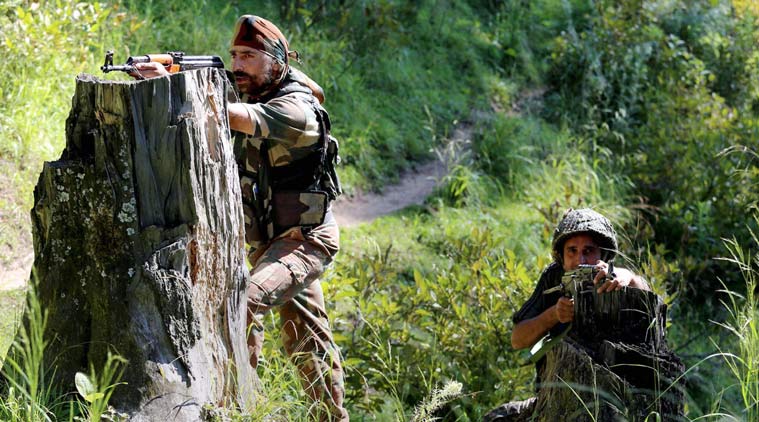 Baramulla : Special Operation Group (SOG) jawans take positions near the house where militants were hiding during an encounter at Rafiabad area of Baramulla district on Thursday. A Pakistani militant was captured alive in the encounter. PTI Photo