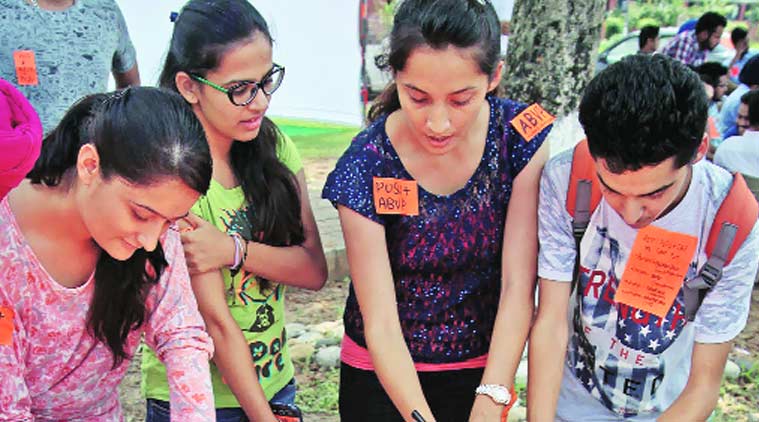 Students prepare party stickers at Panjab University on Sunday. Sumit Malhotra