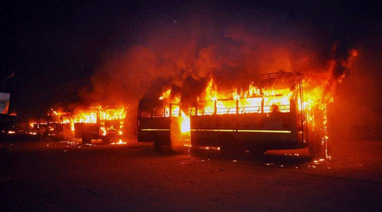 Buses set on fire in Surat on Tuesday night by people after the arrest of Hardik Patel, convener of 'Patidar Anamat Andolan Samiti. (Source: PTI)