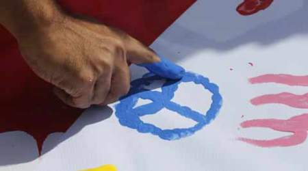 People leave finger painted messages for bombing victims at a plaza across from the Erawan Shrine at Rajprasong intersection. AP Photo