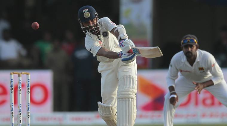 India's Ajinkya Rahane, left, plays a shot as Lahiru Thirimanne watches during the third day's play of the second test cricket match between them in Colombo, Sri Lanka, Saturday, Aug. 22, 2015. (AP Photo/Eranga Jayawardena)