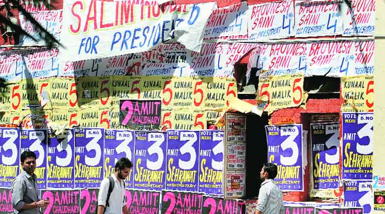 Students walk past a glut of posters at Faculty of Law, North Campus. (Source: Express photo by Ravi Kanojia)
