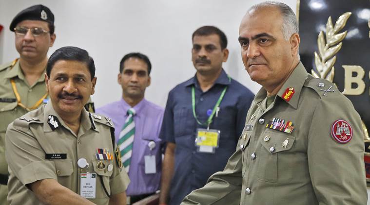 Indian Border Security Force (BSF) Director General D.K. Pathak, left, and Pakistani Rangers Director General (Punjab) Maj Gen Umar Farooq Burki shake hands as they pose for photographs before the start of their delegation level meeting in New Delhi, India, Thursday, Sept. 10, 2015. A 16-member Pakistani delegation of border officers arrived the capital for three-day talks with Indian authorities to discuss unprovoked cease-fire violations alongs its border in the disputed Kashmir region in order to avoid civilian casualties. (AP Photo/Manish Swarup)