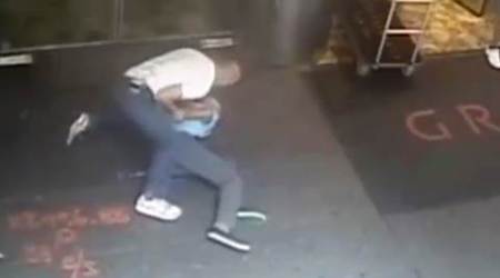 This image taken from a surveillance camera and released by the New York Police Department shows former tennis star James Blake, right, being arrested by plainclothes officer James Frascatore outside of the Grand Hyatt New York hotel on Wednesday, Sept. 9, 2015, in New York. Blake was mistaken for an identity-theft suspect that Police Commissioner William Bratton said looked like Blake's "twin." Bratton apologized to Blake. (NYPD via AP) NO SALES