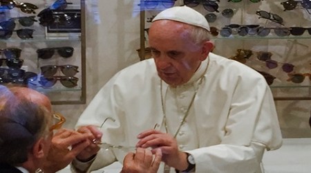 Pope Francis tries on a pair of spectacles in an eyeglass store in via del Babuino, in central Rome, Thursday, Sept. 3, 2015. Pope Francis has slipped out of the Vatican to shop for new lenses for his glasses. (Daniel Soehne via AP)