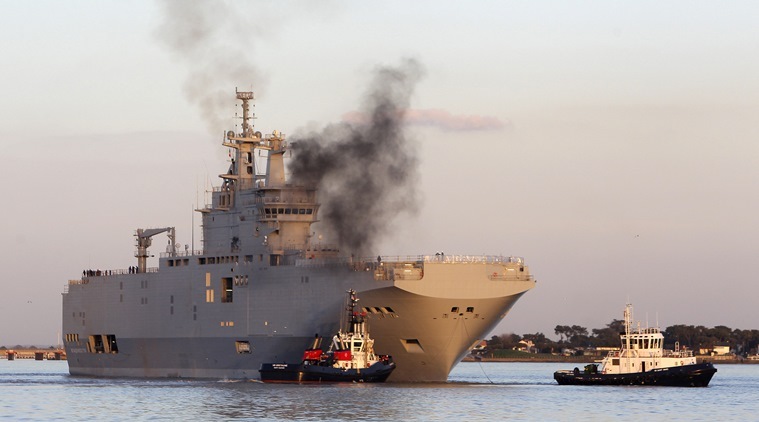 FILE - In this March 5, 2014 file photo, French-built warship BPC Vladivostock, designed to strengthen Russia's ability to deploy troops, tanks and helicopter gunships, leaves the Saint Nazaire's harbor, western France. France says Wednesday Sept.23, 2015 it is selling two Mistral-class warships originally intended for Russia to Egypt instead. Mistral-class warships can carry 16 helicopter gunships, 700 troops and up to 50 armored vehicles. (AP Photo/David Vincent, File)