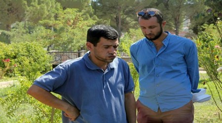 Abdullah Kurdi, 40, left, father of Syrian boys Aylan, 3, and Galip, 5, who were washed up drowned on a beach near Turkish resort of Bodrum on Wednesday, waits for the delivery of their bodies outside a morgue in Mugla, Turkey, Thursday, Sept. 3, 2015. Images of Aylans body on the beach, have heightened global attention to a wave of migration, driven by war and deprivation, that is unparalleled since World War II. Man at right is unidentfied. (Tolga Adanali/Depo Photos via AP)