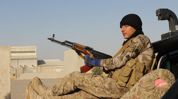 An Afghan National Army soldier rests after he arrives in a camp, outside of Kunduz city. (Source: AP photo)