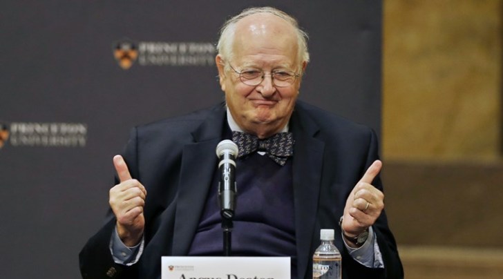 Angus Deaton gestures at a gathering at Princeton University after it was announced that he won the Nobel prize in economics (AP photo)