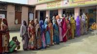 Women wait in a line to cast their vote outside a polling station in Samastipur, Bihar panchayat poll, UP panchayat poll, lucknow police, lucknow news