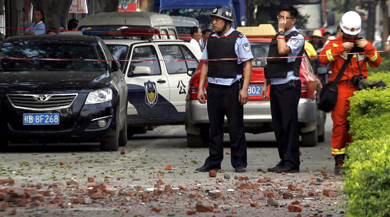 Chinese police officers stand at the scene of an explosion in Liucheng county in southern China's Guangxi Zhuang Autonomous Region Thursday, Oct. 1, 2015. (Source: AP photo)