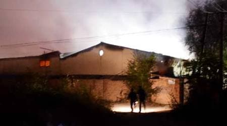 In this photo released by China's Xinhua News Agency, people run near a blast site at Xiditou Village in the Beichen District of Tianjin, north China, Tuesday, Oct. 13, 2015. (Xinhua via AP)